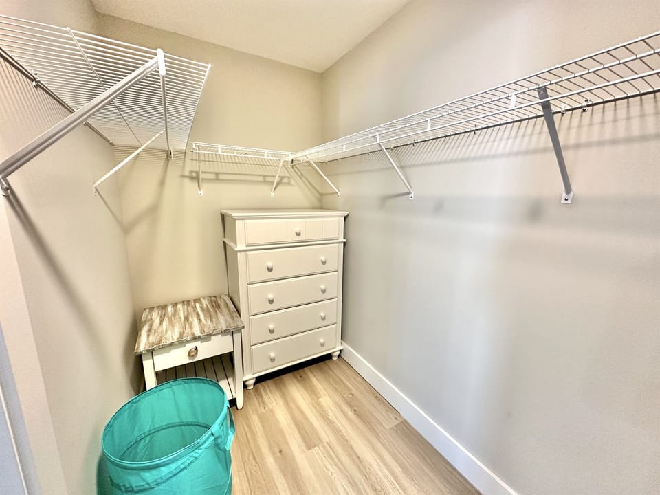 Spacious master bathroom with walk-in shower and large walk-in closet for a comfortable extended stay.