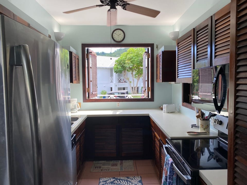 Kitchen w/refrigerator, stove, microwave, coffee maker, dishwasher and dishes