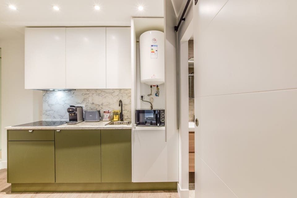 Main view of the kitchen with appliances and bathroom in the background