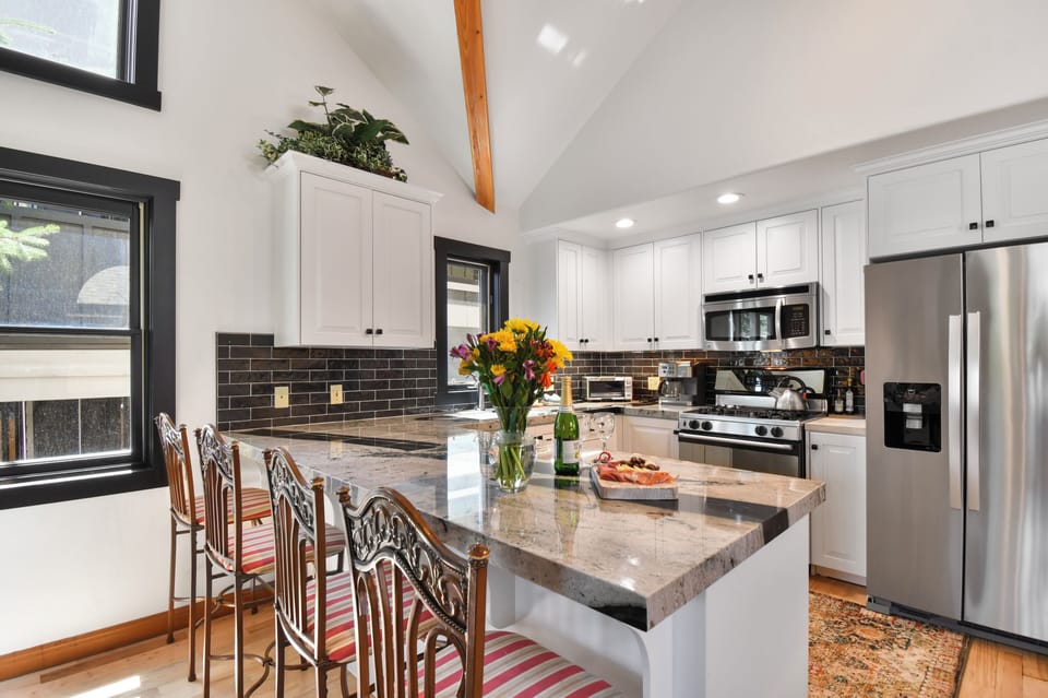 Gather around the spacious granite island, perfect for casual breakfasts, evening appetizers, or entertaining family and friends.