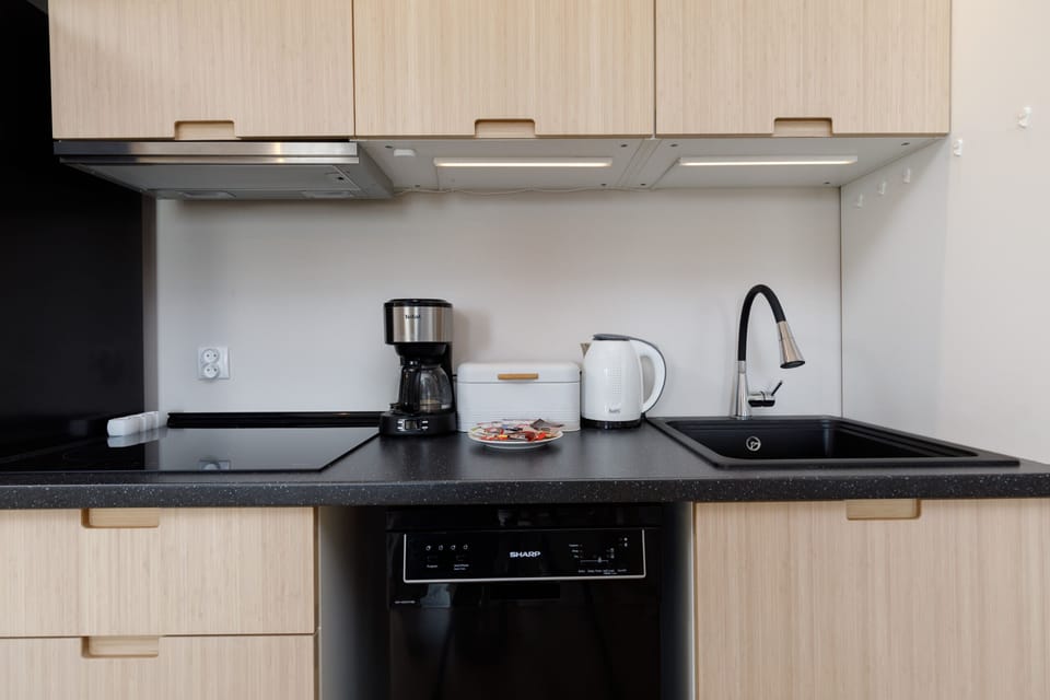 Kitchenette with oven and refrigerator. 