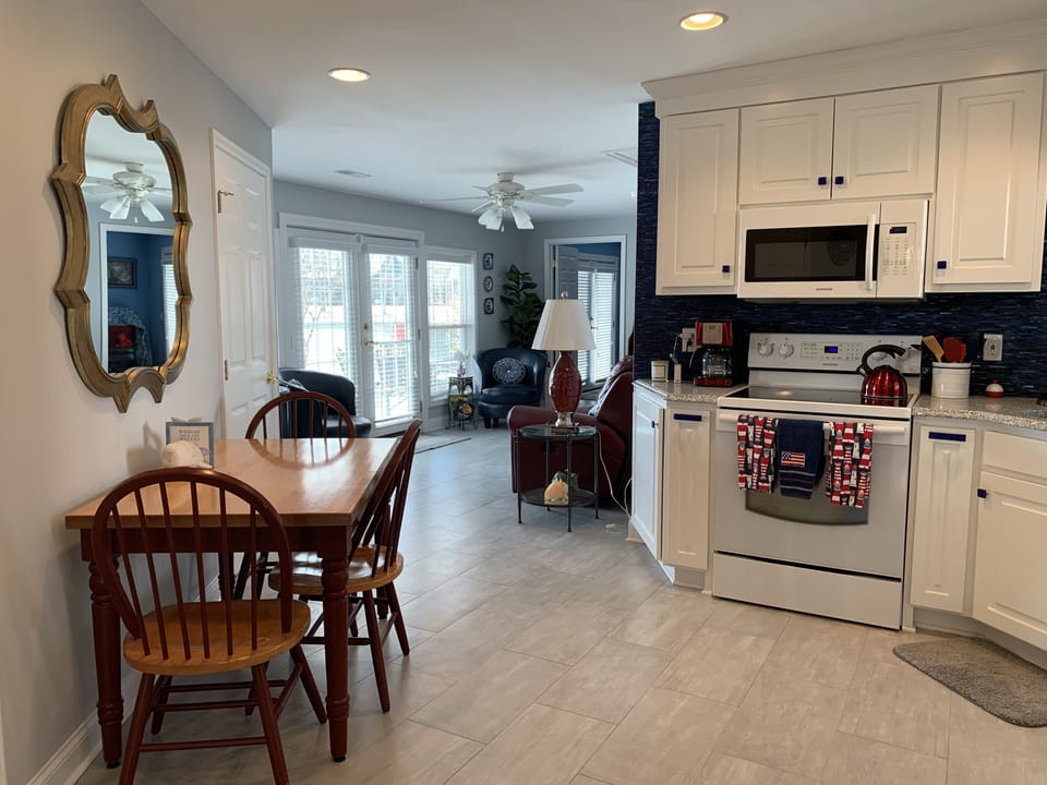 View from kitchen to living space and french doors to the deck and lake