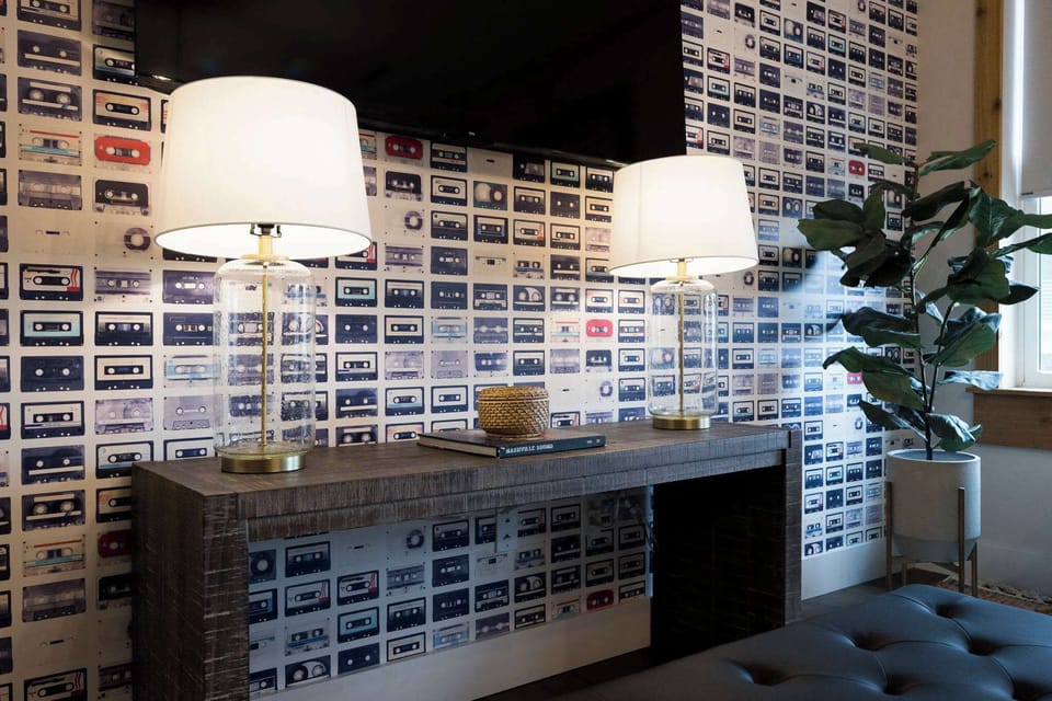 Immerse yourself in a blast from the past with a living room featuring a stunning display of cassette tapes on the wall, perfect for any audiophile.