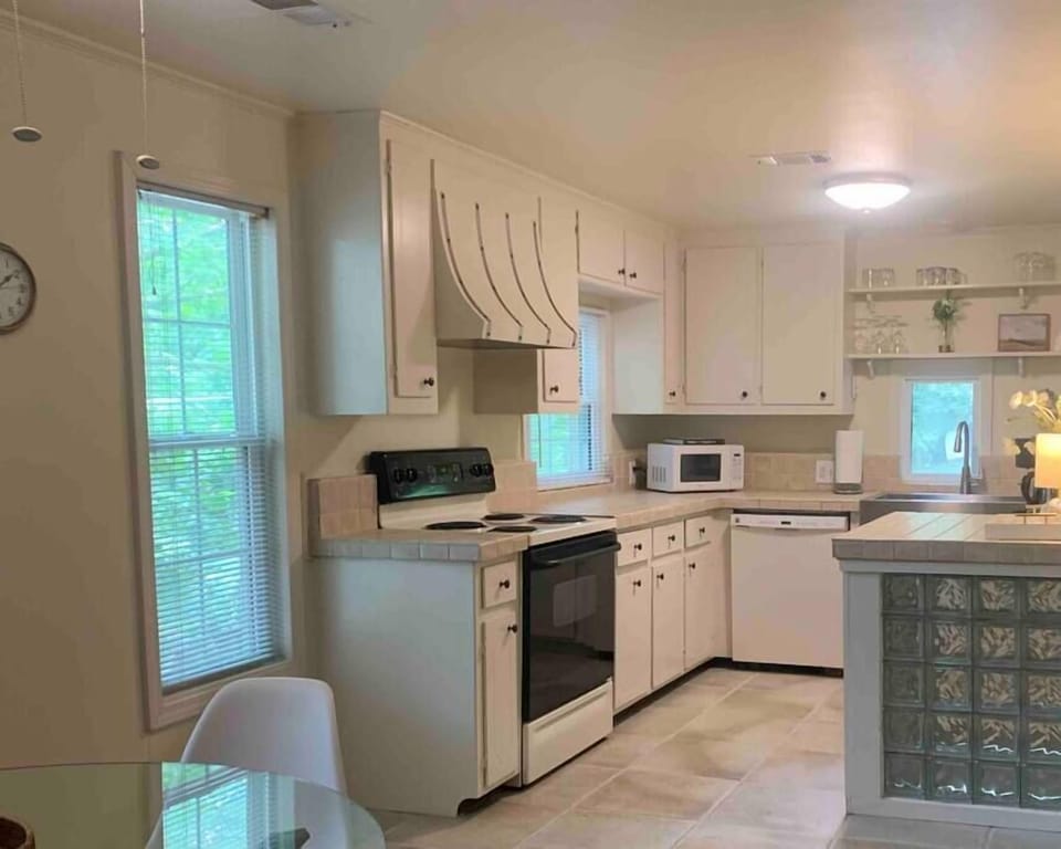 Fully equipped kitchen with forest views for peaceful meal prep.