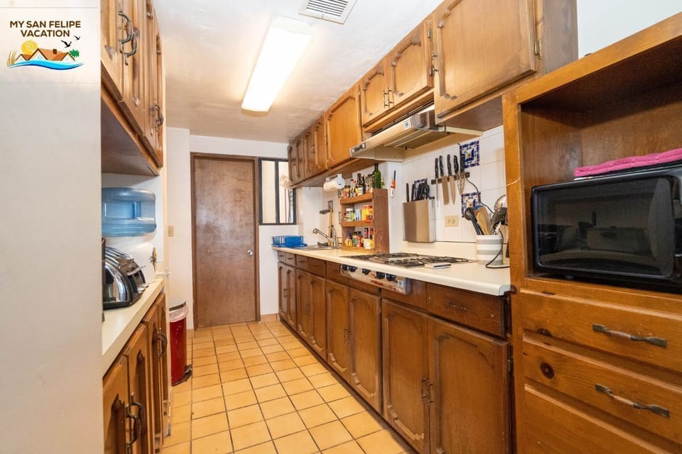 Cook with ease in the full kitchen of Casa Lopaz at La Hacienda San Felipe BC MX — stove, fridge, and counter space included.