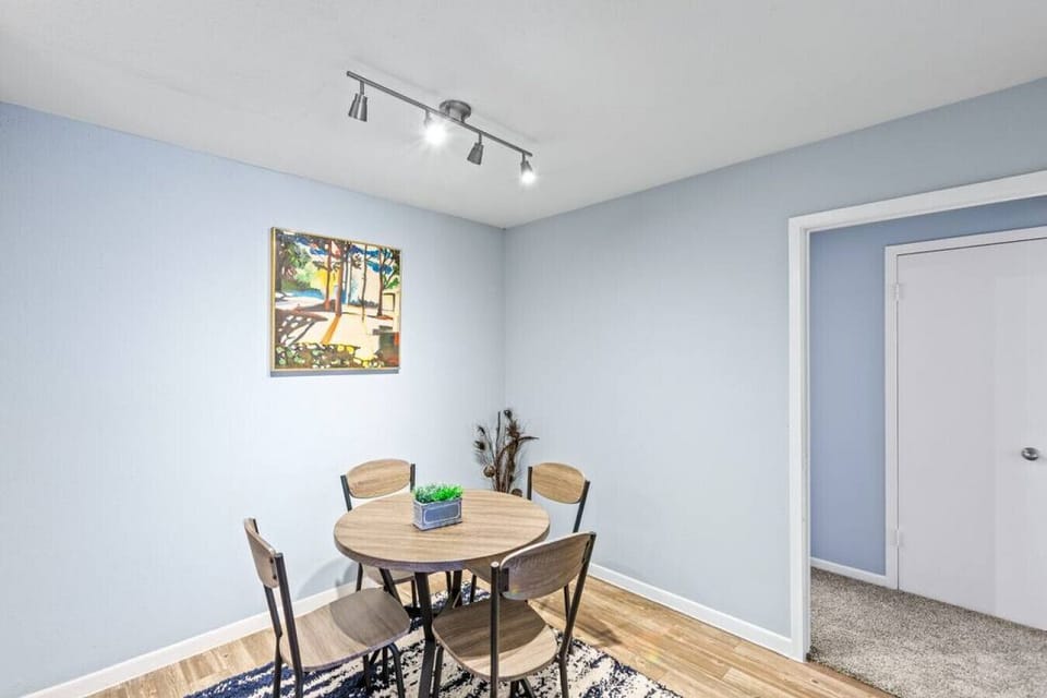 Four-seater dining table offering a dedicated space for guest meals.