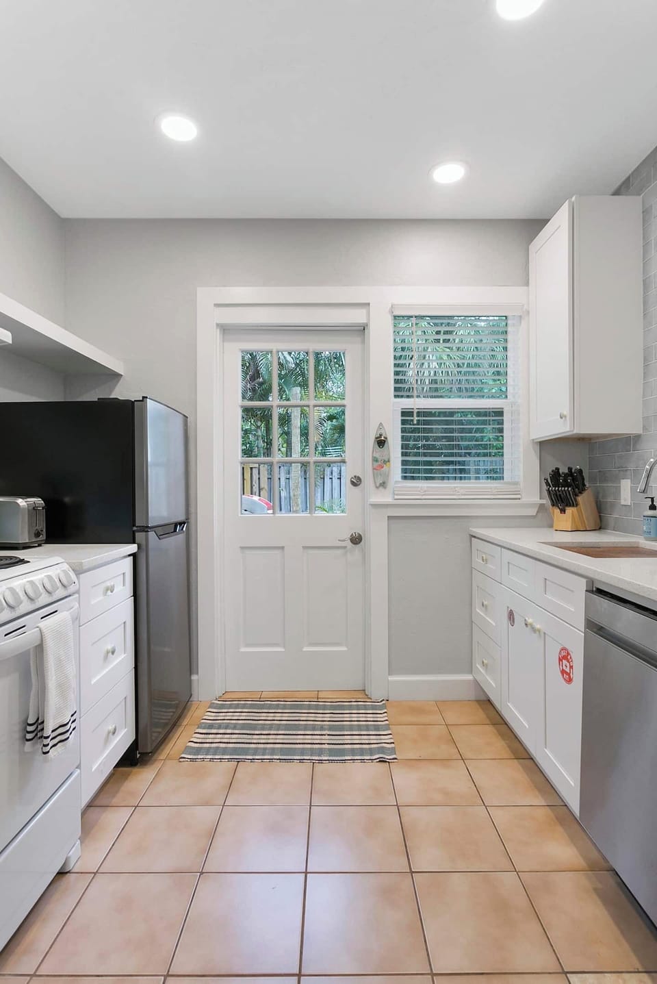 Brand New Kitchen with apartment-size appliances makes for extremely efficient use of a small space.  20" four burner range, 10 cu ft refrigerator, 18" stainless steel dish washer, 24" front load Samsung washer & dryer