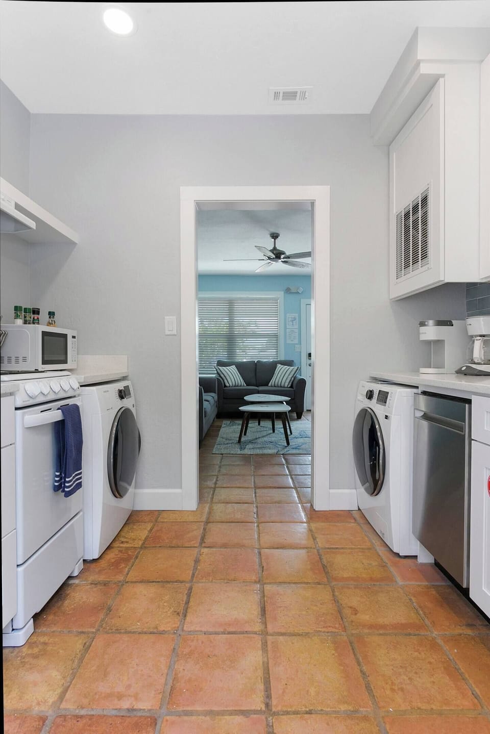 Brand New Kitchen with apartment-size appliances makes for extremely efficient use of a small space.  24" front load Samsung washer and dryer, microwave, 18" dishwasher, 20" four burner stove.