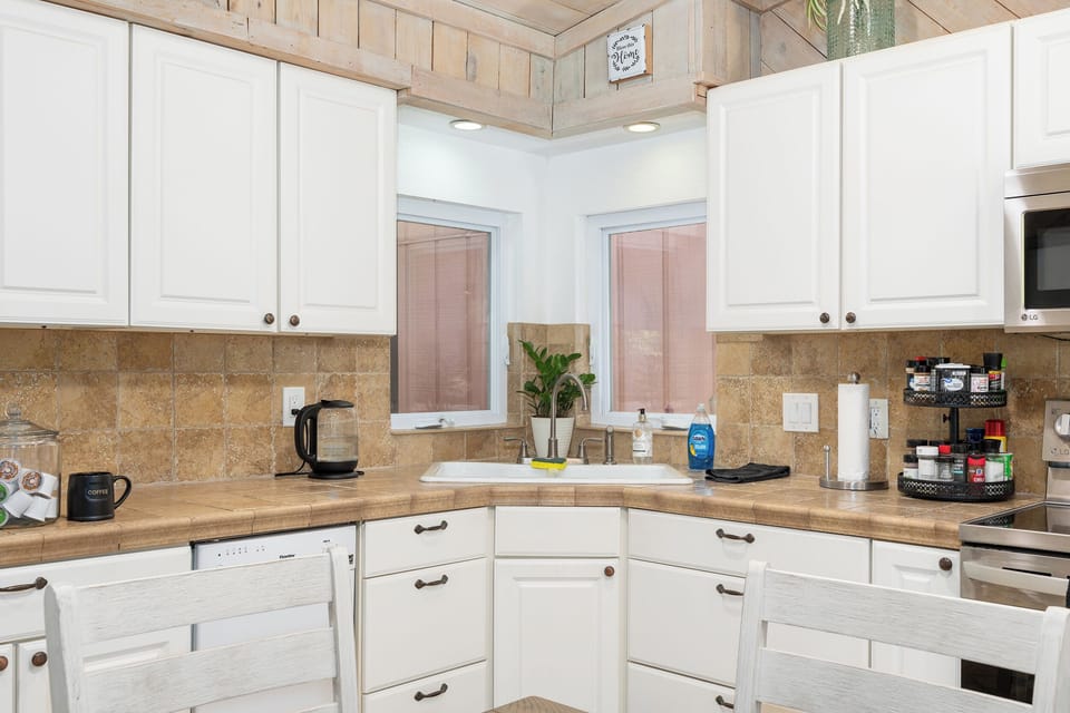 Double kitchen sink with excellent lighting. Tons of pots and utensils.