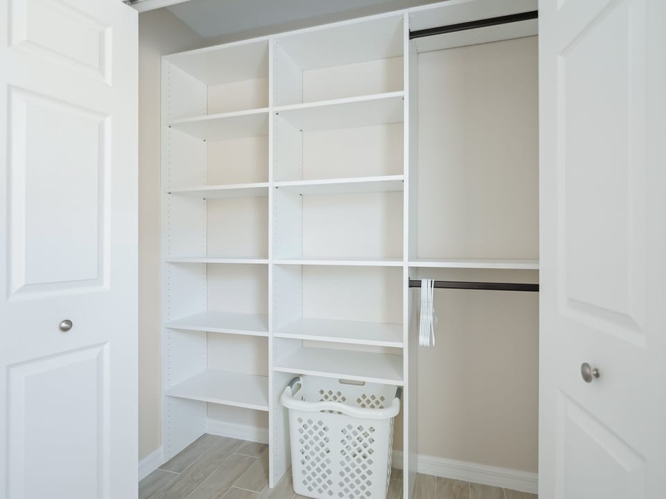 Closet with plenty of space for hanging clothes or stacking clothes on shelves.