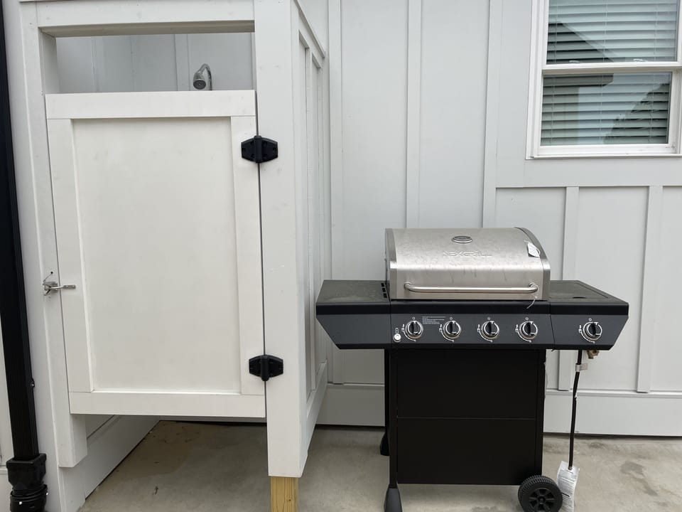 Outdoor shower and gas grill.