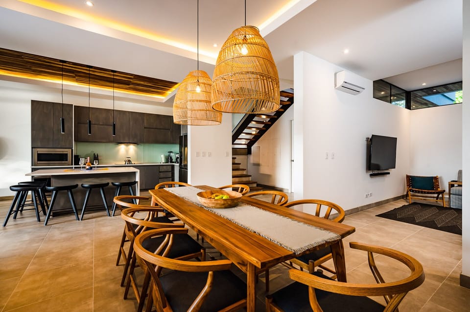 A living room and a kitchen come together to create an entertainment space