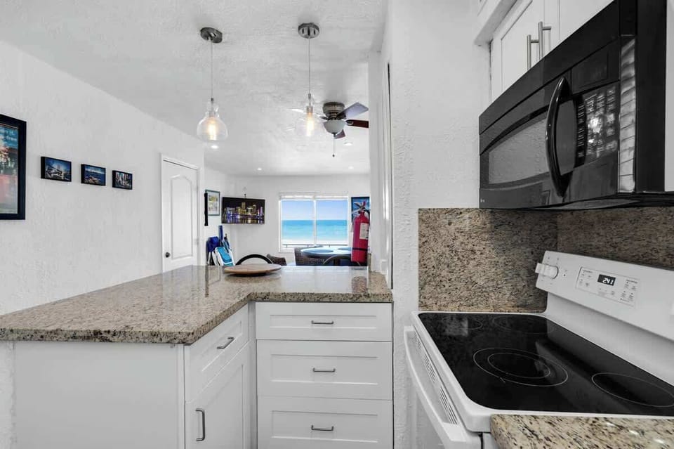 Bright, open, and beach-ready! This vacation kitchen flows into a cozy living space—ideal for guests who love convenience and coastal style.