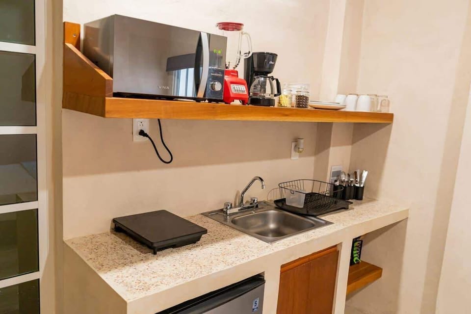 Kitchenette with cookware and appliances