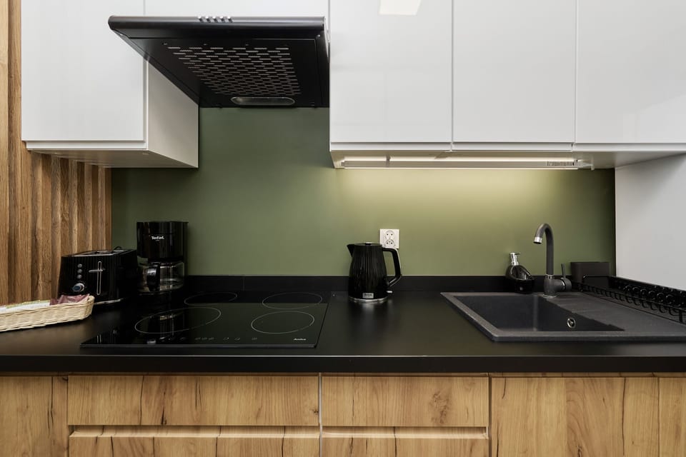 The sleek design of the kitchenette blending seamlessly with the living area.