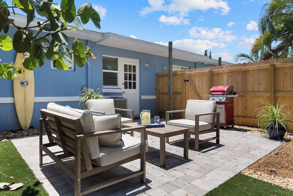 215 Fenced yard with conversation seating for 4, cold water shower, bar-b-que grill, brick paver patio and turf.  Interconnecting gate between units.