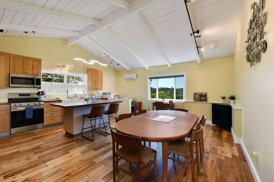 Kitchen with dining table and another workstation 