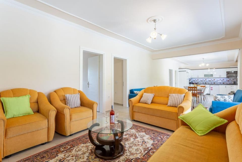 Open-plan living room with sofas, dining area, kitchen, A/C, WiFi internet, satellite TV, and terrace access