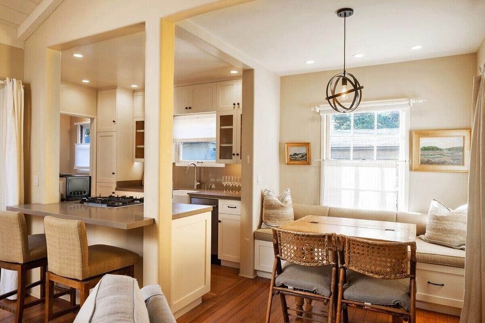  Fully appointed kitchen dining table with bench seating and chairs.