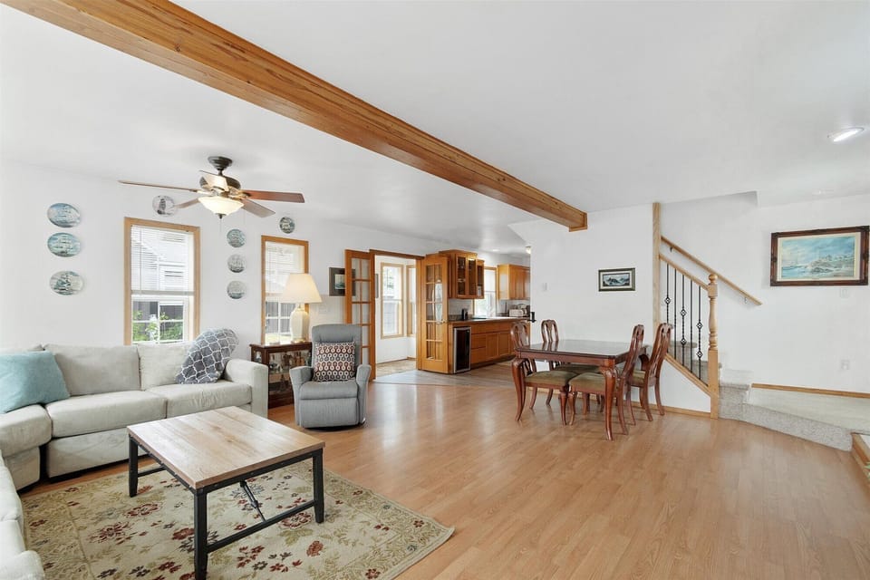 The dining area showcases a wooden table with seating for 4