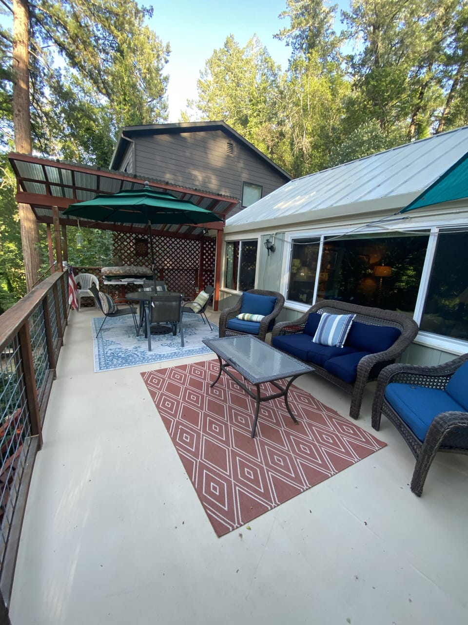 Main level deck off the living room and kitchen, outdoor dining and seating