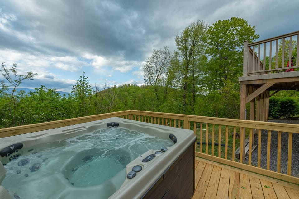 Relax & enjoy mountain views in the newly-added hot tub with a glass of wine.
