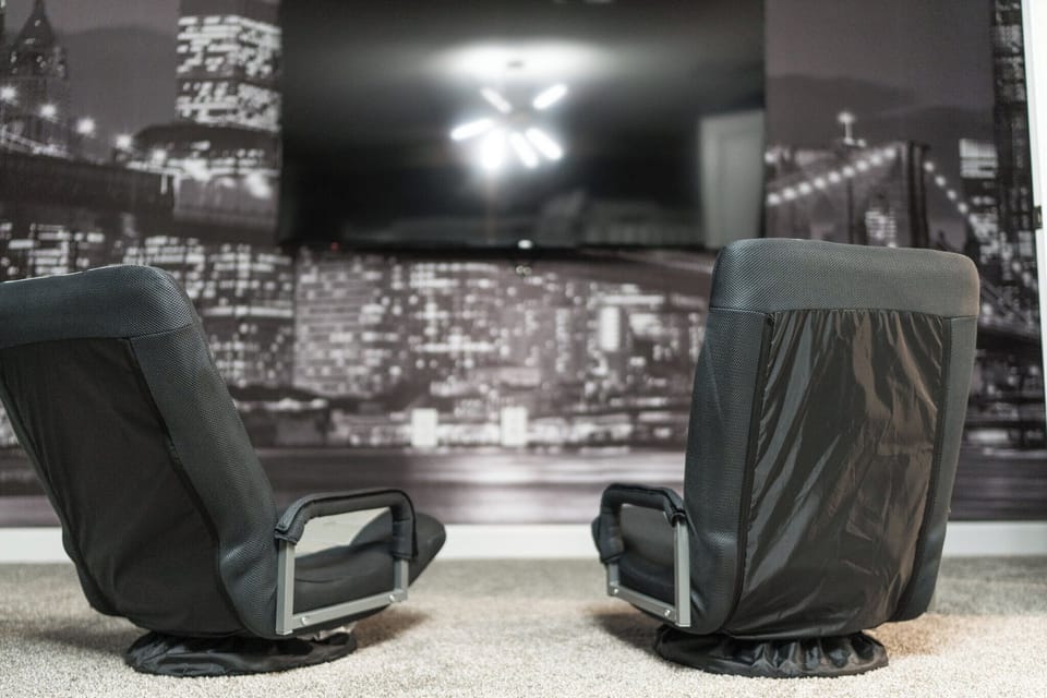 Level up your stay with our gaming setup featuring comfy chairs.