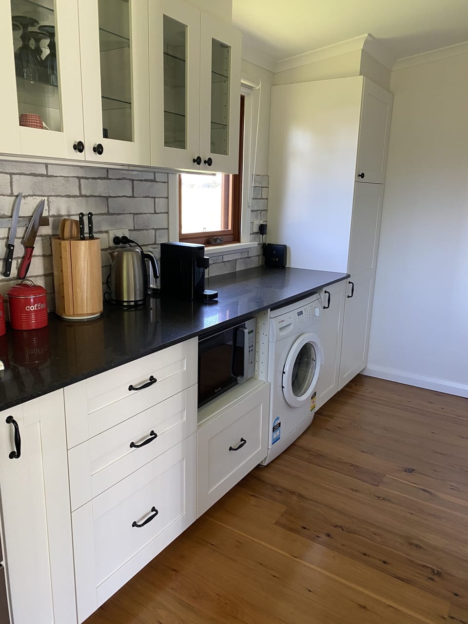 Kitchen including laundry facilities.