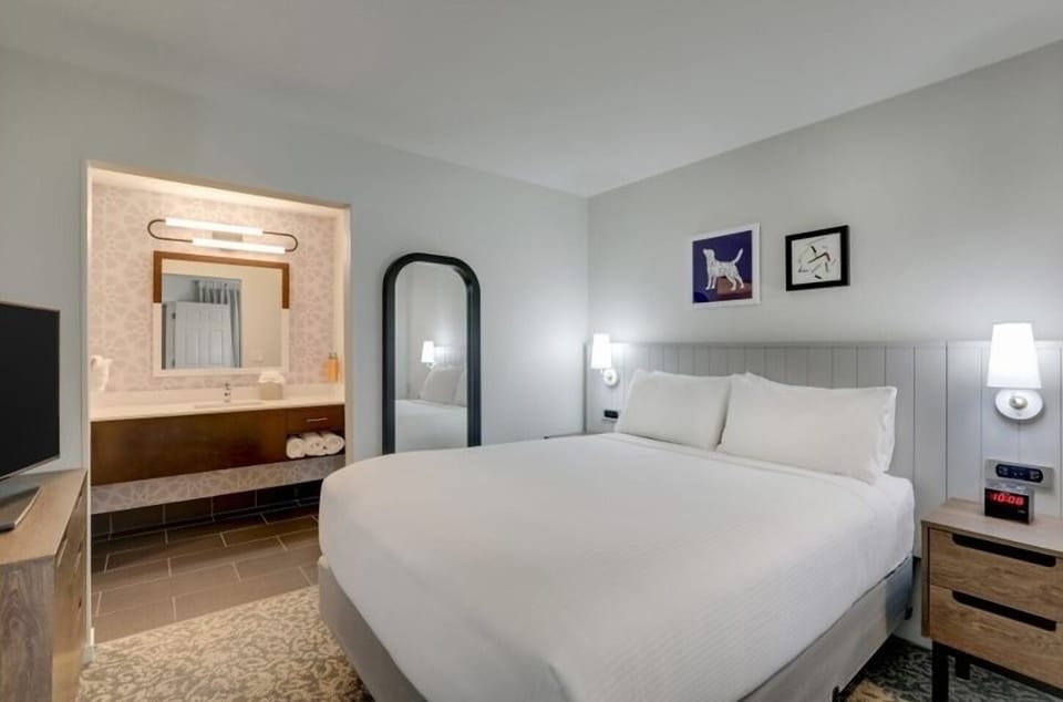 Unwind in crisp linens with a bright, spa-like ensuite.