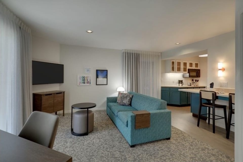Settle into the airy lounge, steps from your full kitchen.