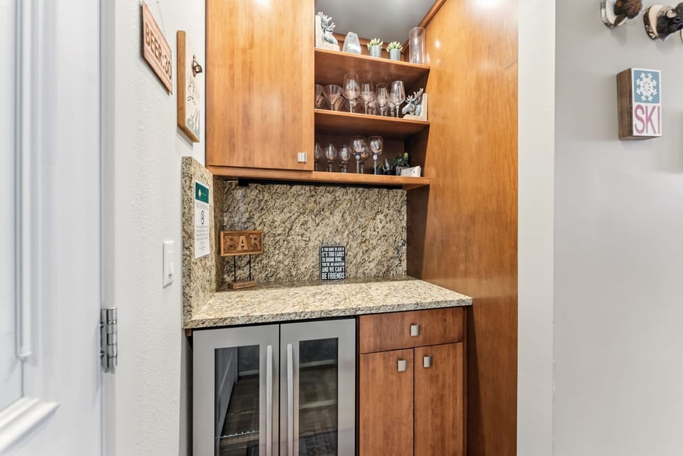 Your stylish wet bar awaits with granite counters, wine storage, and everything needed for après-ski cocktails.