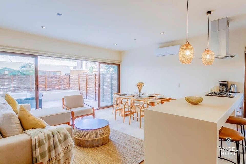 The open floor plan encompasses the kitchen, living and dining areas and is surrounded by floor-to-ceiling sliding glass doors