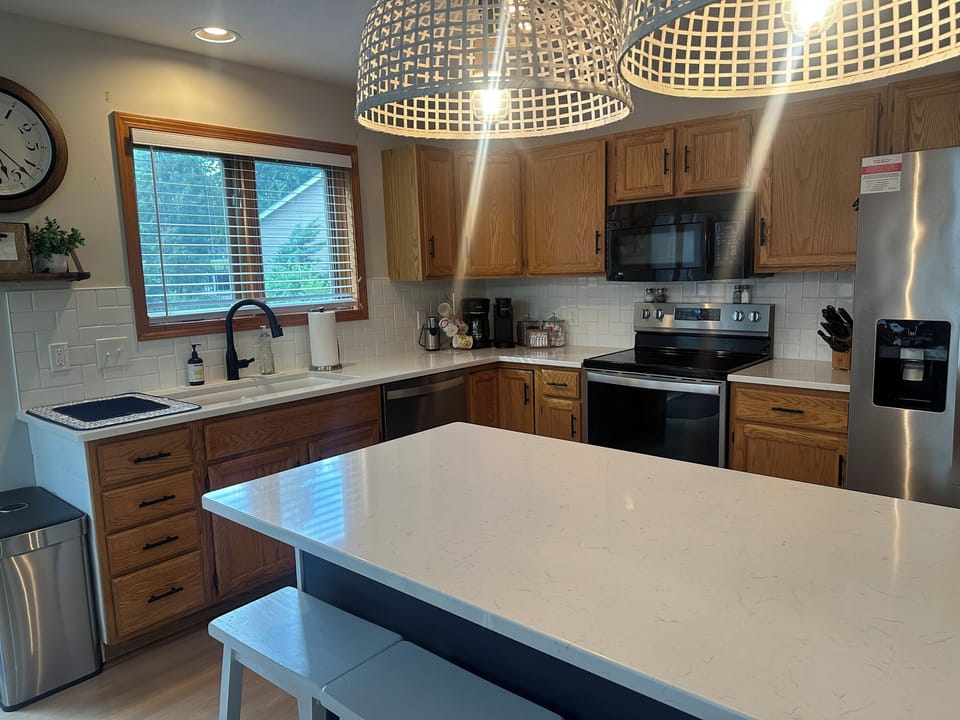 Fully stocked kitchen with island seating for 4.