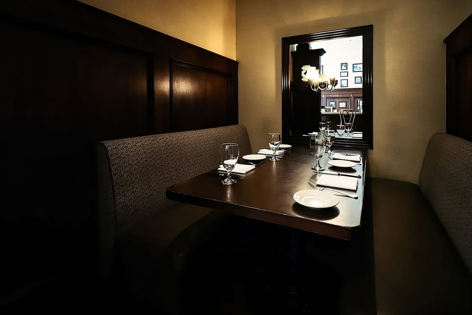 Share late-night bites in a snug booth with moody lighting.