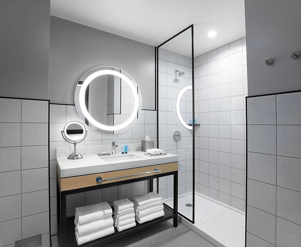 Refresh under a sleek glass shower and bright vanity.