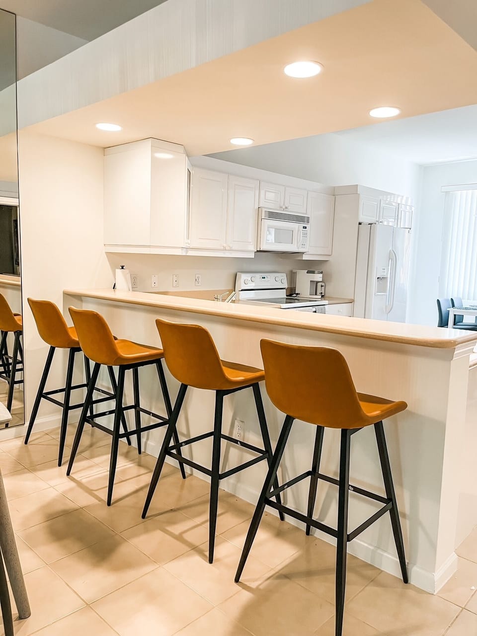This bright kitchen is the heart of your Naples vacation, with breakfast bar.
