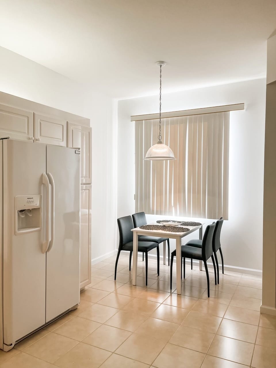 Share meals in a welcoming dining space set for four with natural light.
