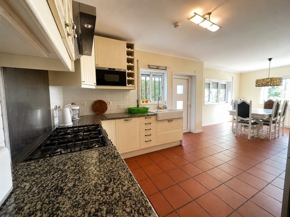 Kitchen overlooking the terrace and woodland