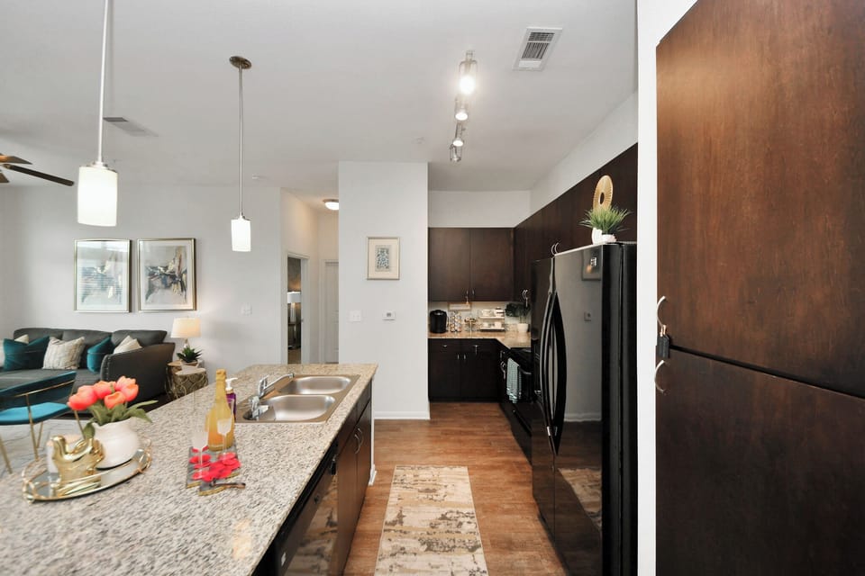 Fully stocked kitchen with cooking appliances, pots and pans, blender, air fryer