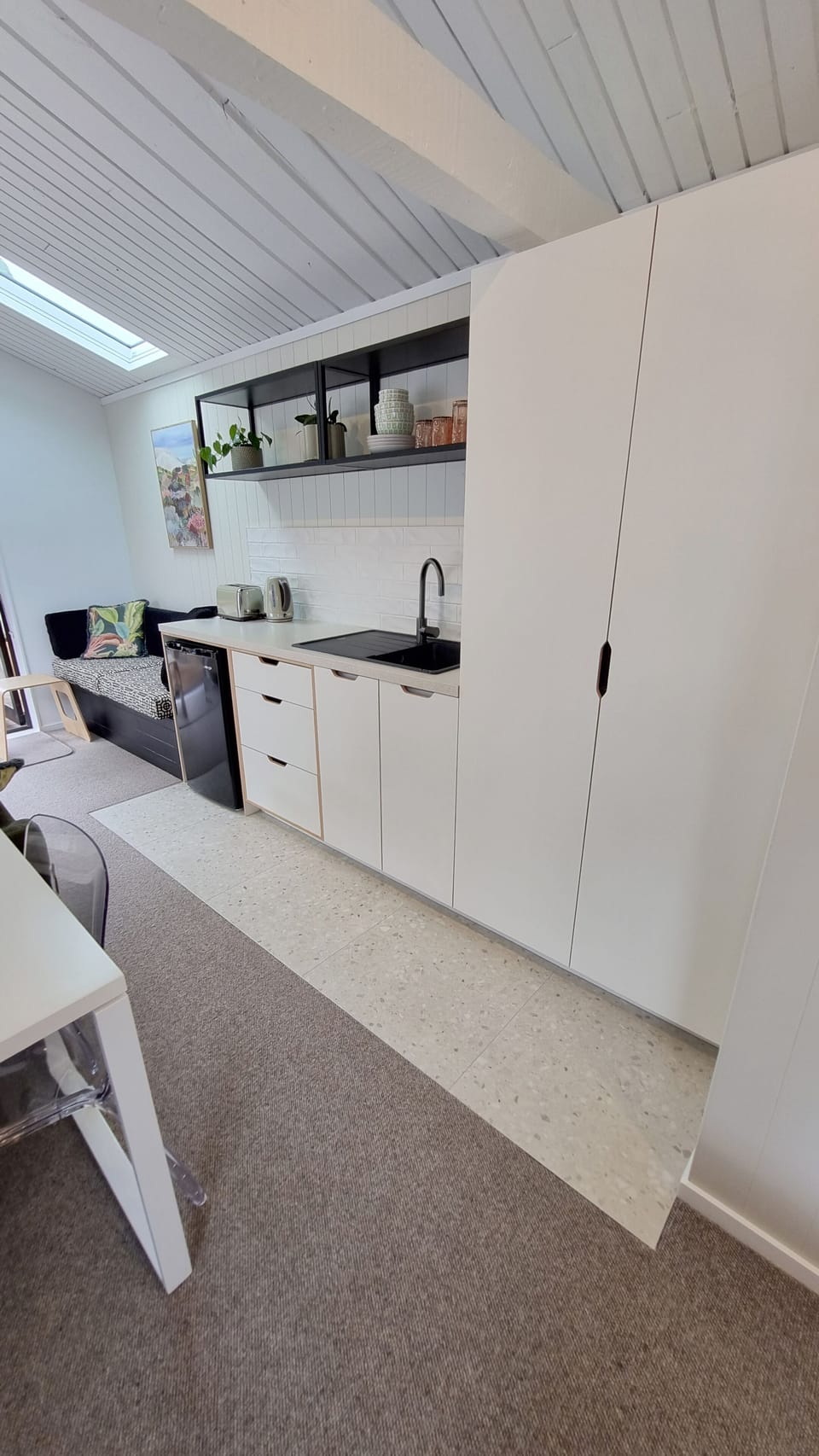 Brand new kitchen with fridge, sink, appliances and storage.