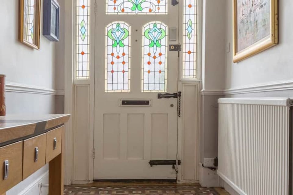 Edwardian stained glass front door with entry code system.