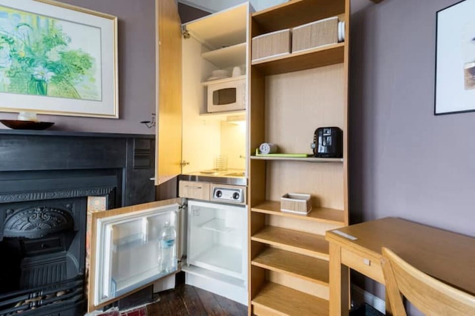 Convenient fully equipped kitchenette with microwave and fridge freezer.