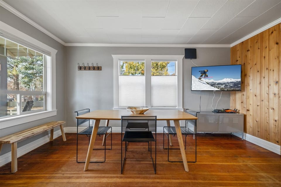 Bright and open living room with dining for four, large smart TV