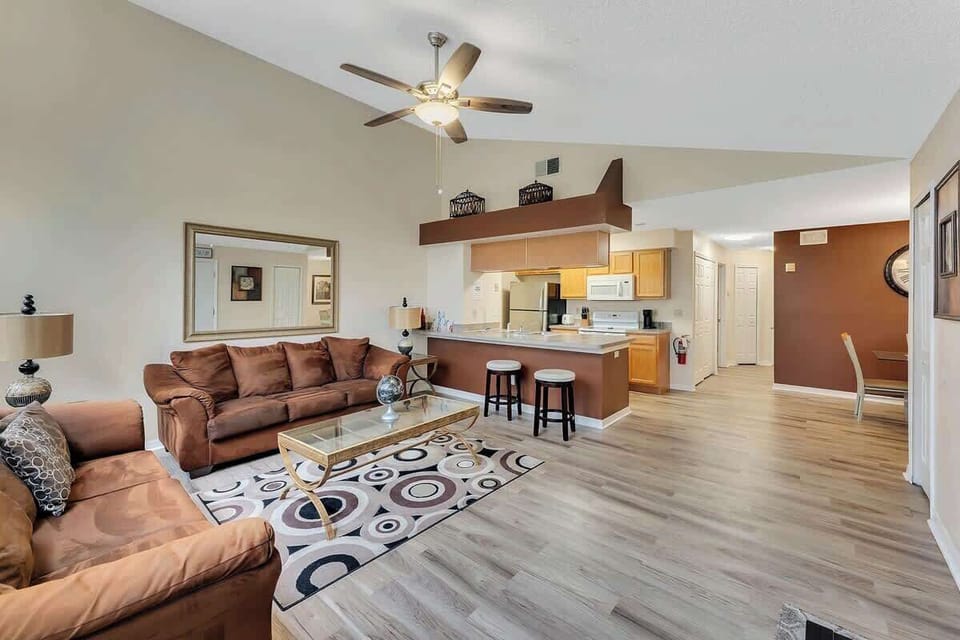 Open-concept living area with vaulted ceilings and a kitchen bar for casual dining.
