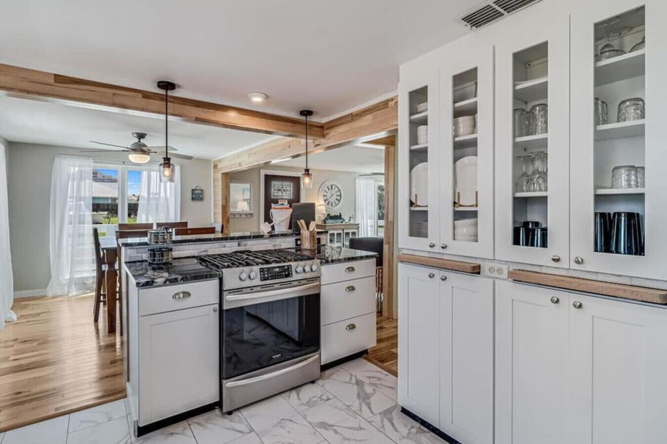 Full kitchen with gas range, modern cabinetry, and open layout.