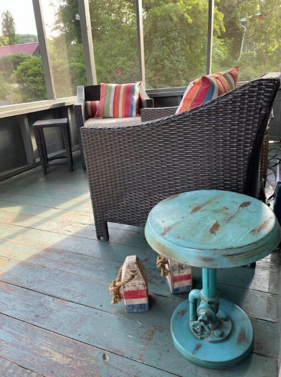 Screened front porch with comfy seating options.