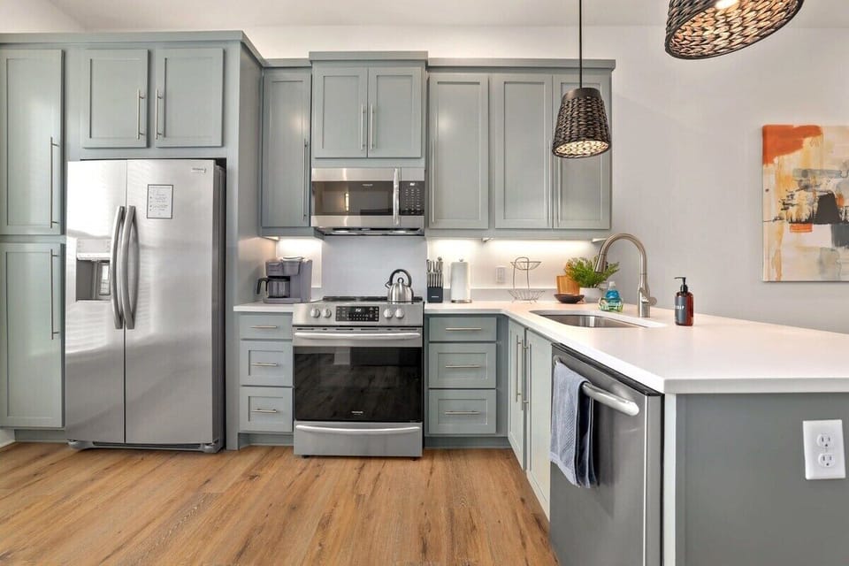 Directly at the top of the stairs, you'll see our fully stocked kitchen. Here, you'll find plenty of built-in storage as well as everything you need to whip up your favorite meal or baked goods.