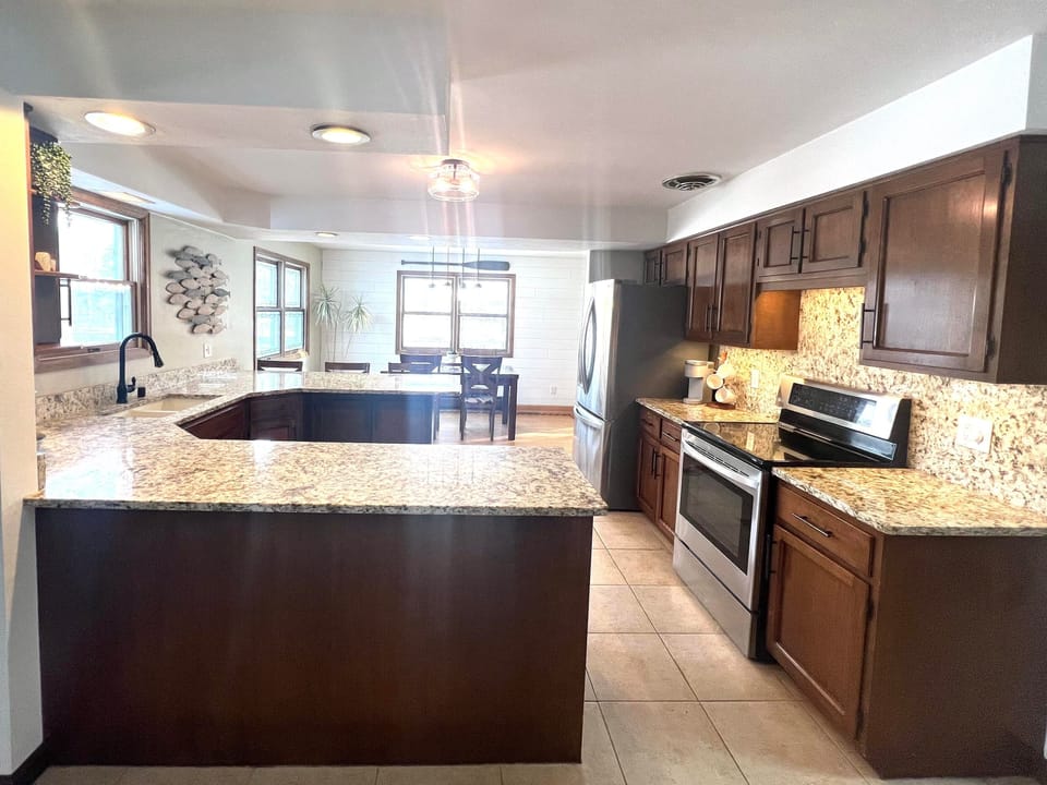 Renovated kitchen overlooks channel. Granite countertops, stainless appliances 