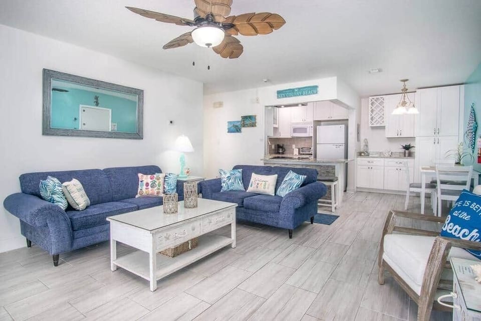 The living room has tile floors, couch, loveseat and two chairs for maximum comfort.