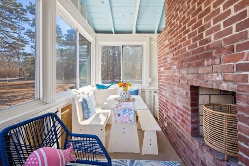 The light and bright 3-season room featuring dining/gaming table